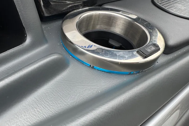 Slide: The Image of 2024 Regency 230 DL3 boat cup holder with blue LED lighting. - 38