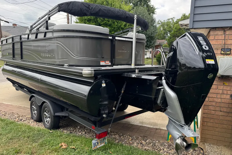 Slide: The Image of 2024 Regency 230 DL3 pontoon boat with Mercury 250 V8 engine on trailer. - 7