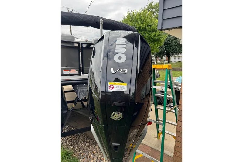 Slide: The Image of 2024 Regency 230 DL3 boat with a powerful 250 V8 Mercury outboard engine. - 8