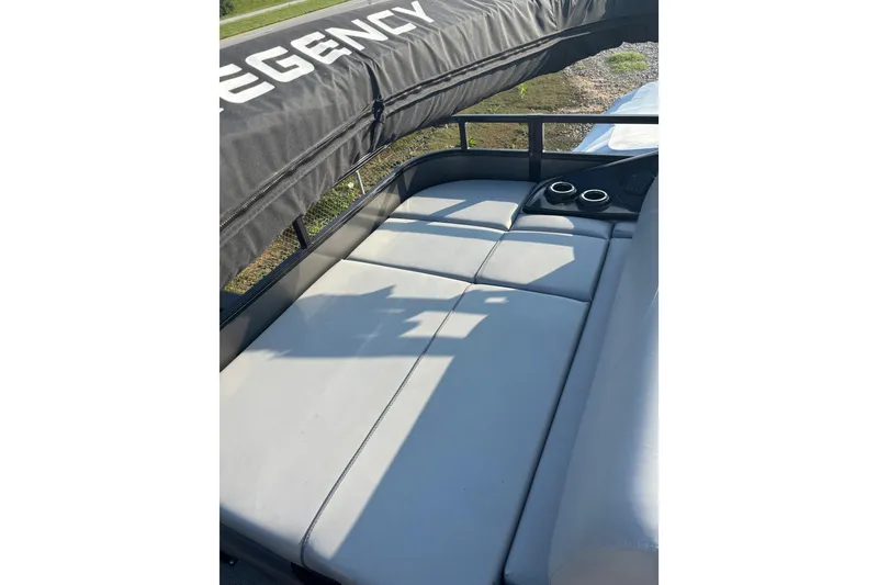 Slide: The Image of 2021 Regency 250 DL3 boat interior with cushioned seating and cup holders. - 14