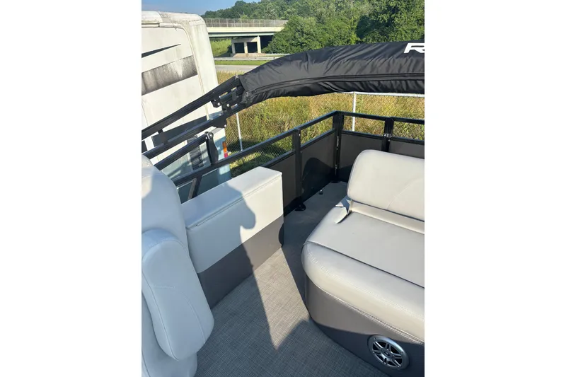 Slide: The Image of 2021 Regency 250 DL3 pontoon boat interior with seating and railing. - 15