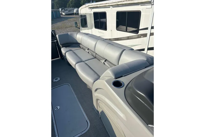 Slide: The Image of 2021 Regency 250 DL3 pontoon boat with gray seating and cup holder. - 16