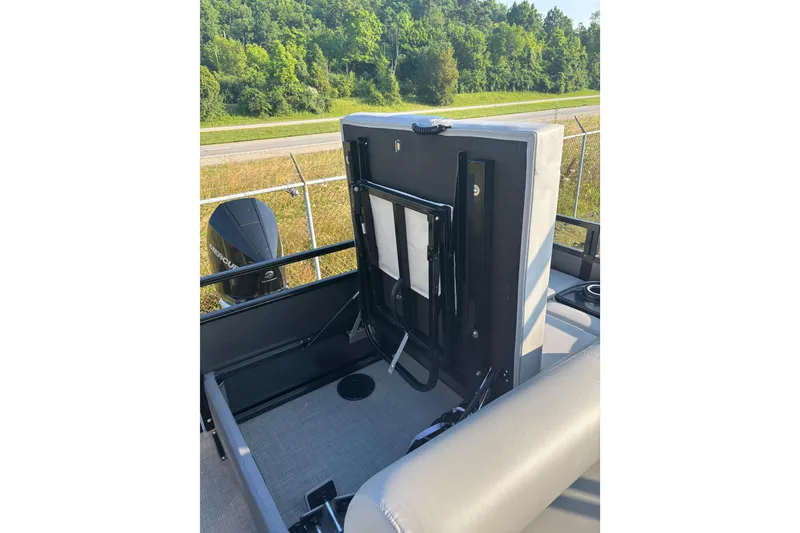 Slide: The Image of 2021 Regency 250 DL3 boat interior with folded seat and Mercury engine. - 17