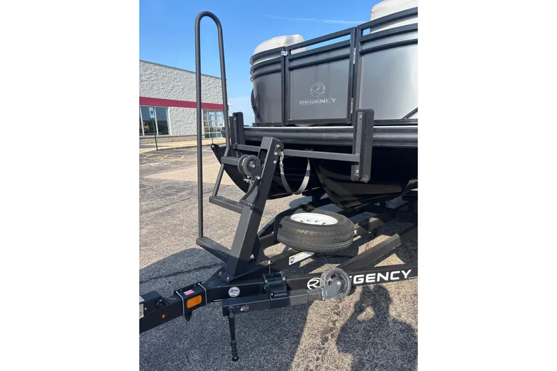 Slide: The Image of 2021 Regency 250 DL3 boat trailer with ladder and spare tire in parking lot. - 22