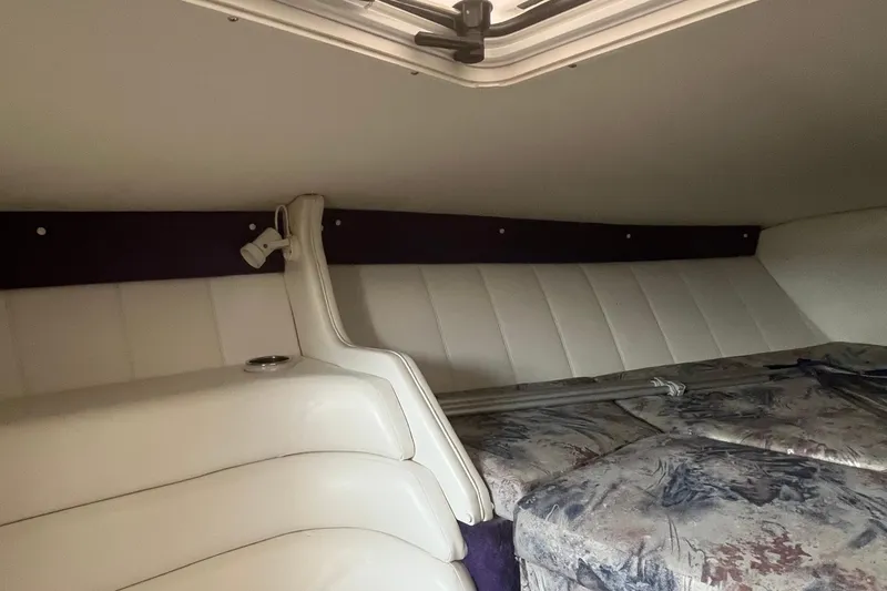 Slide: The Image of Interior cabin of a 2001 Powerquest 280 Silencer boat with white upholstery. - 16