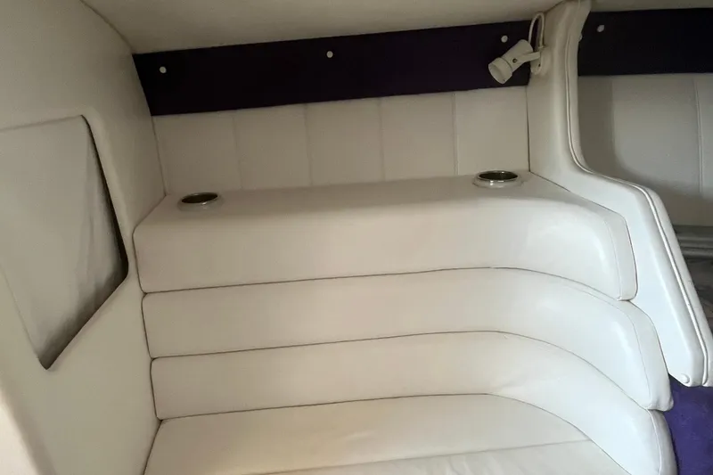Slide: The Image of Interior of 2001 Powerquest 280 Silencer boat with white cushioned seating. - 17