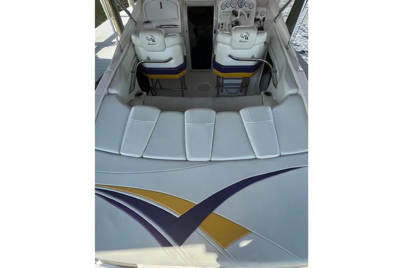 Slide: The Image of 2001 Powerquest 280 Silencer boat interior with white seating and colorful accents. - 19