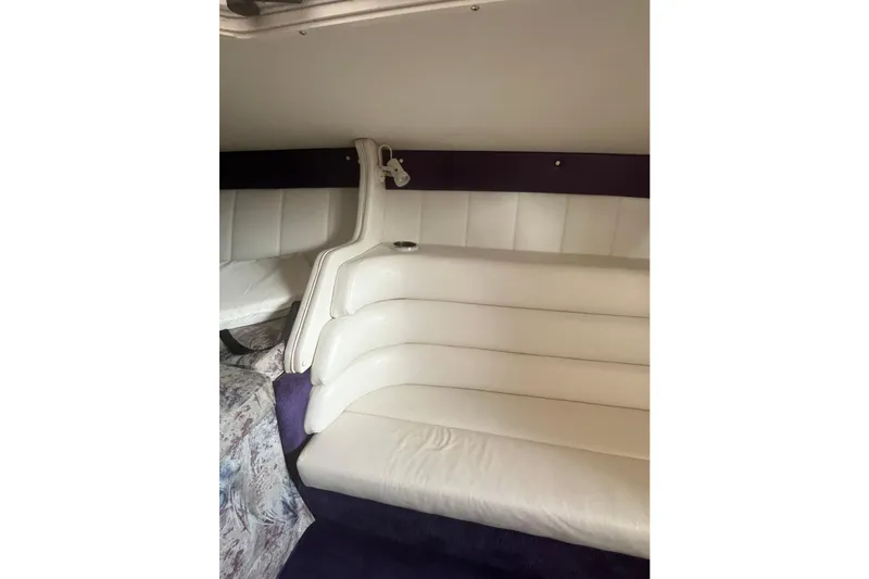 Slide: The Image of Interior of 2001 Powerquest 280 Silencer boat with white leather seating. - 21