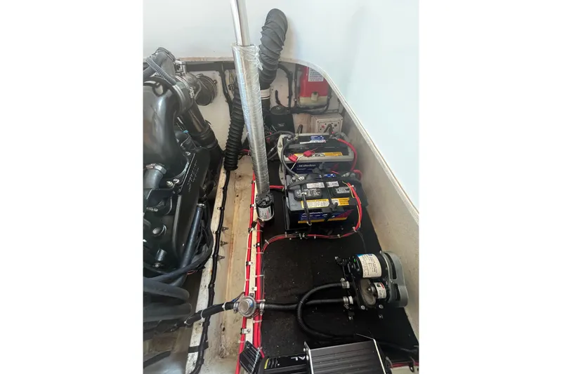 Slide: The Image of Engine compartment of a 2001 Powerquest 280 Silencer boat, showing batteries and wiring. - 23