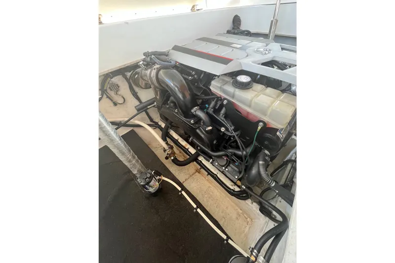 Slide: The Image of Engine compartment of a 2001 Powerquest 280 Silencer boat, showcasing detailed components. - 24