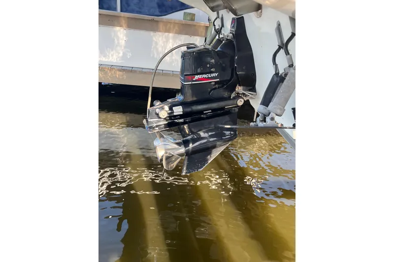 Slide: The Image of Outboard motor of a 2001 Powerquest 280 Silencer boat in water. - 26