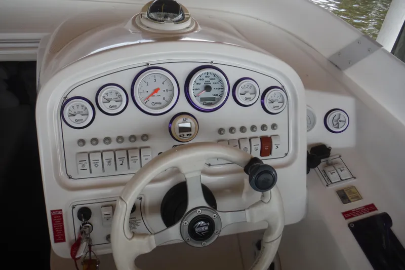 Slide: The Image of Dashboard of a 2001 Powerquest 280 Silencer boat with gauges and steering wheel. - 7
