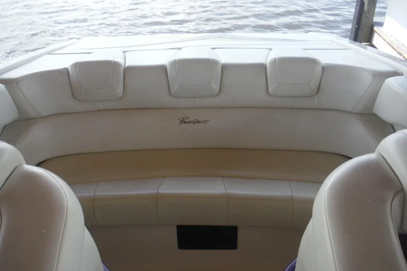 Slide: The Image of 2001 Powerquest 280 Silencer boat interior with beige seating and water view. - 8