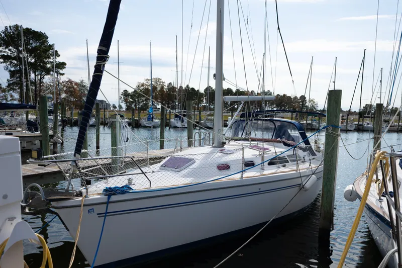 The Image of Catalina 350 sailboat from 2005 docked at a marina with surrounding boats. - 1