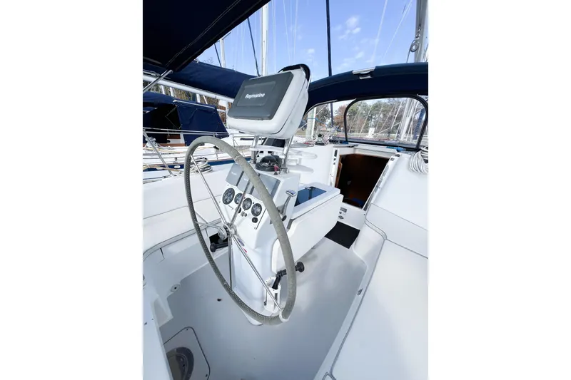 Slide: The Image of Cockpit of 2005 Catalina 350 sailboat with steering wheel and navigation equipment. - 11