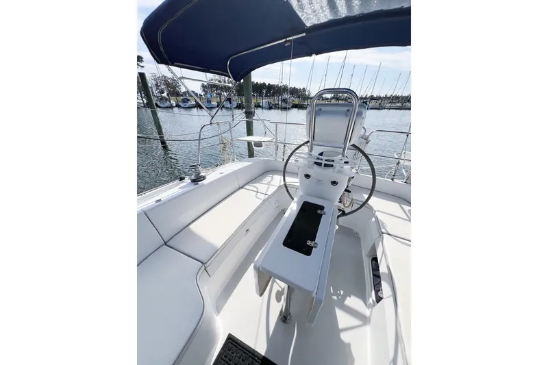 Slide: The Image of Cockpit of 2005 Catalina 350 sailboat with steering wheel and seating, docked at marina. - 14