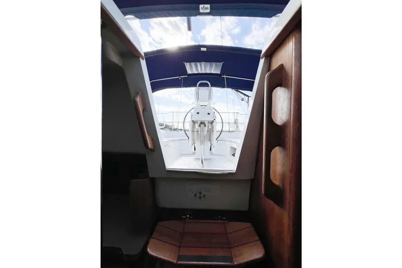 Slide: The Image of Interior view of a 2005 Catalina 350 sailboat cockpit with blue canopy. - 18