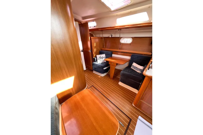 Slide: The Image of Interior of 2005 Catalina 350 sailboat with wooden furnishings and cozy seating. - 21