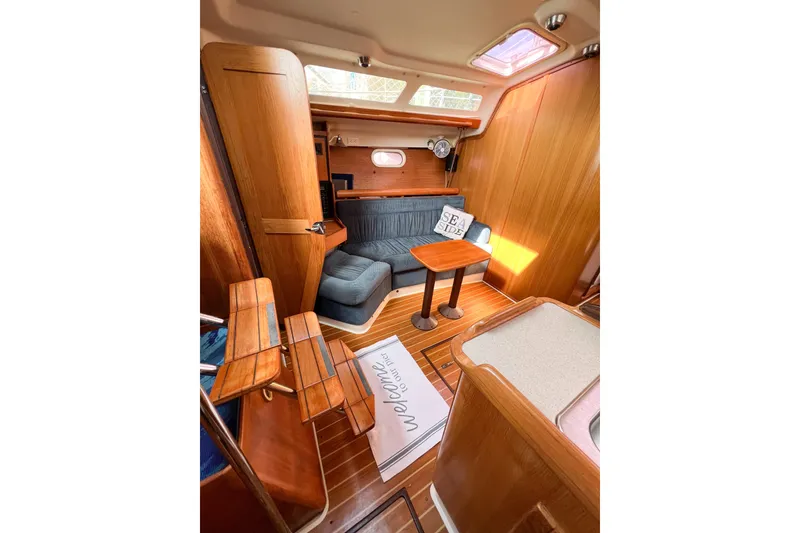 Slide: The Image of Interior of 2005 Catalina 350 sailboat with cozy seating and wooden finishes. - 25