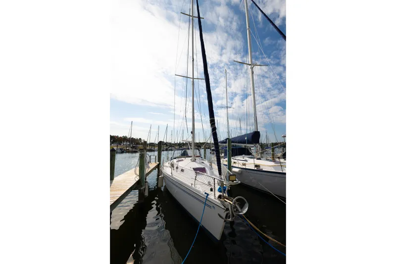 Slide: The Image of 2005 Catalina 350 sailboat docked at marina under blue sky. - 3