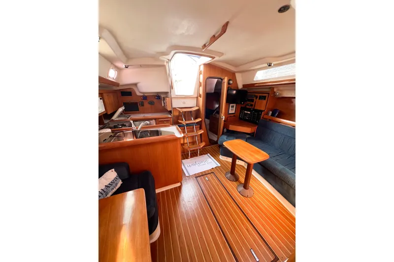 Slide: The Image of Interior of 2005 Catalina 350 sailboat with wooden furnishings and cozy seating area. - 31