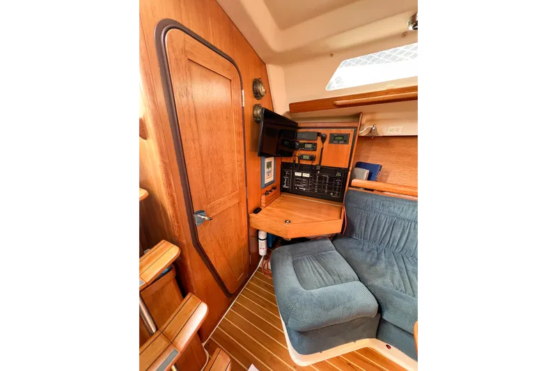 Slide: The Image of Interior of 2005 Catalina 350 sailboat with navigation station and seating area. - 33