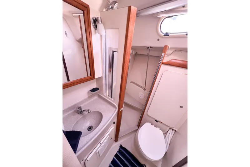 Slide: The Image of Bathroom interior of a 2005 Catalina 350 yacht, featuring sink and toilet. - 36