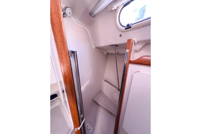 Slide: The Image of Interior of a 2005 Catalina 350 sailboat, featuring a compact shower area. - 37