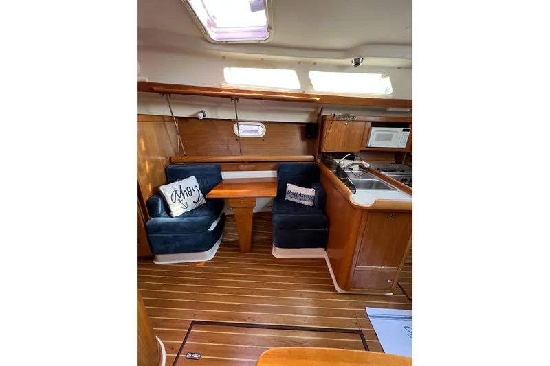 Slide: The Image of Interior of 2005 Catalina 350 sailboat with cozy seating and kitchenette. - 40