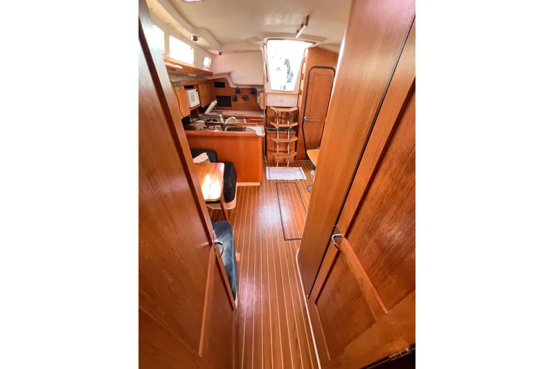 Slide: The Image of Interior of 2005 Catalina 350 sailboat with wood finish and compact kitchen area. - 45
