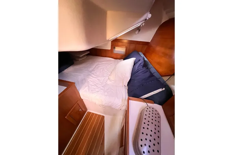 Slide: The Image of Cozy cabin interior of 2005 Catalina 350 sailboat with bed and wooden accents. - 47