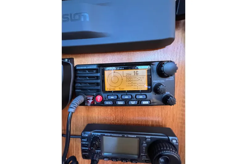 Slide: The Image of Marine radio equipment on 2005 Catalina 350 sailboat, featuring Standard Horizon and Icom transceivers. - 52