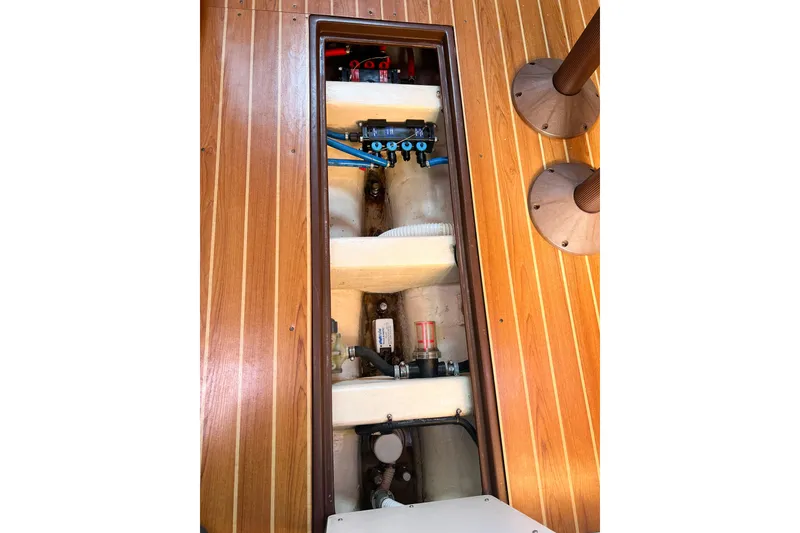 Slide: The Image of Open hatch on Catalina 350 sailboat, showcasing interior components and wooden flooring. - 53