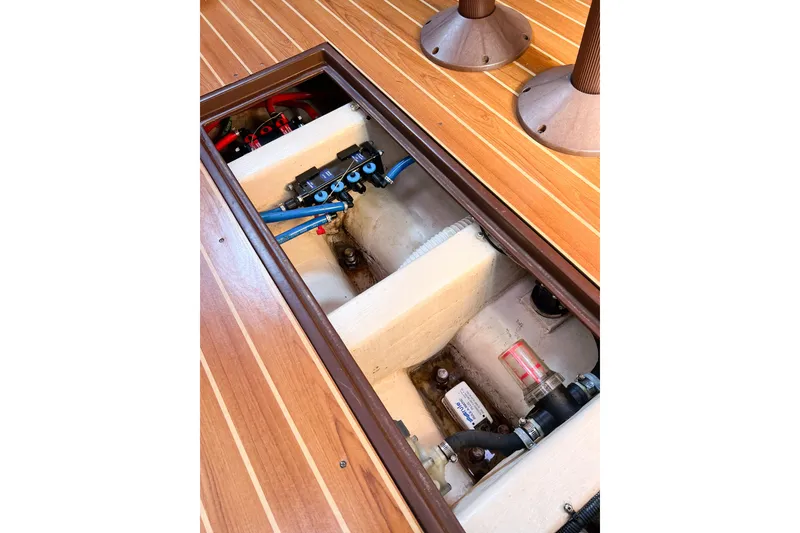 Slide: The Image of Engine compartment of a 2005 Catalina 350 sailboat with visible components and wiring. - 54