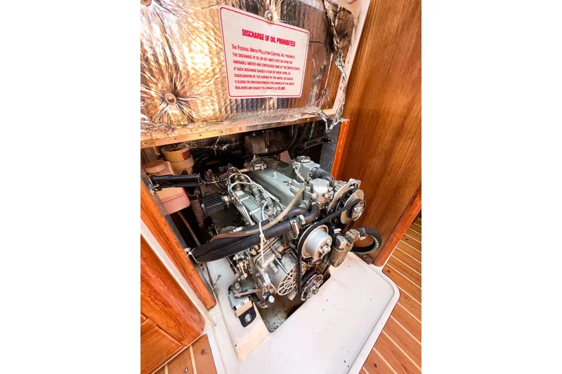 Slide: The Image of Engine compartment of a 2005 Catalina 350 sailboat, showcasing mechanical components. - 55