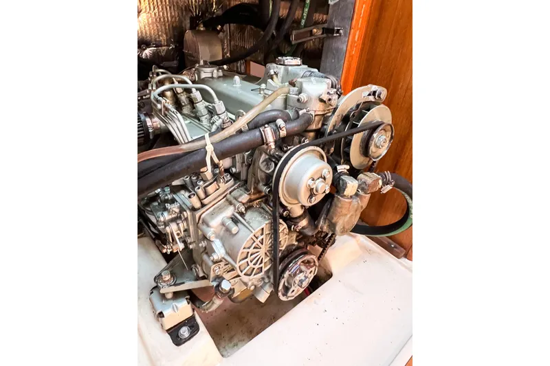Slide: The Image of Engine of a 2005 Catalina 350 sailboat, showcasing mechanical components and belts. - 56