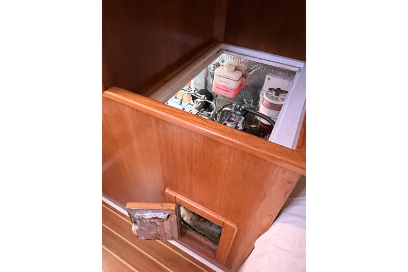Slide: The Image of Engine compartment of a 2005 Catalina 350 sailboat, showcasing mechanical components. - 57
