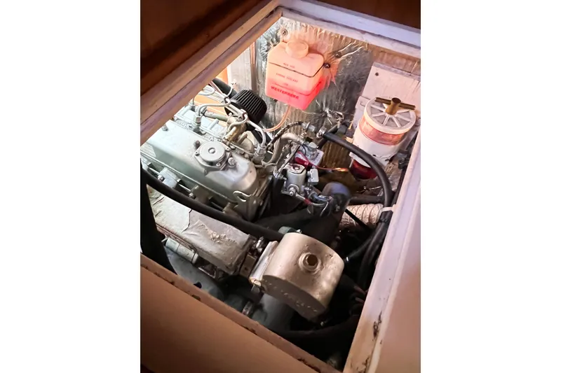 Slide: The Image of Engine compartment of a 2005 Catalina 350 sailboat, showcasing mechanical components and wiring. - 58