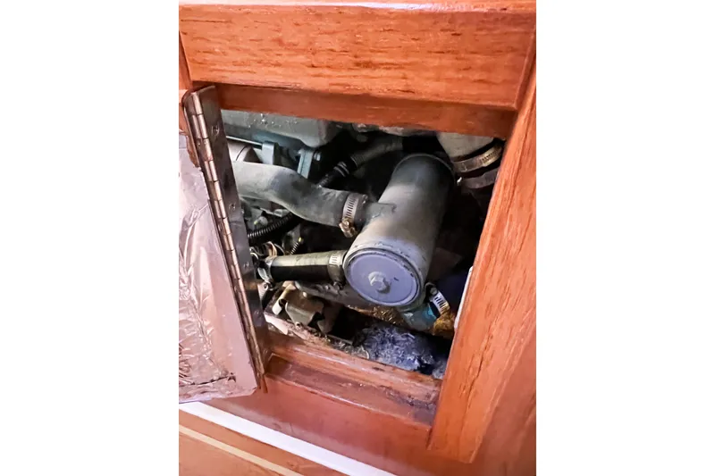 Slide: The Image of Engine compartment of a 2005 Catalina 350 sailboat, showing mechanical components. - 59