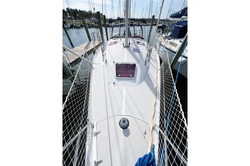 Slide: The Image of 2005 Catalina 350 sailboat deck view at marina, featuring safety netting and mooring lines. - 6