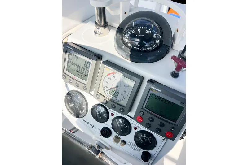 Slide: The Image of Control panel of a 2005 Catalina 350 sailboat with navigation instruments. - 63