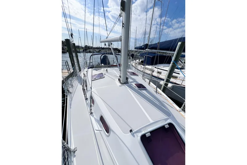 Slide: The Image of 2005 Catalina 350 sailboat docked at marina under blue sky. - 7