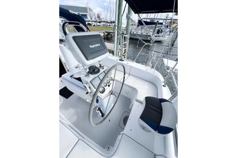 Slide: The Image of Cockpit of 2005 Catalina 350 sailboat with steering wheel and navigation equipment. - 8