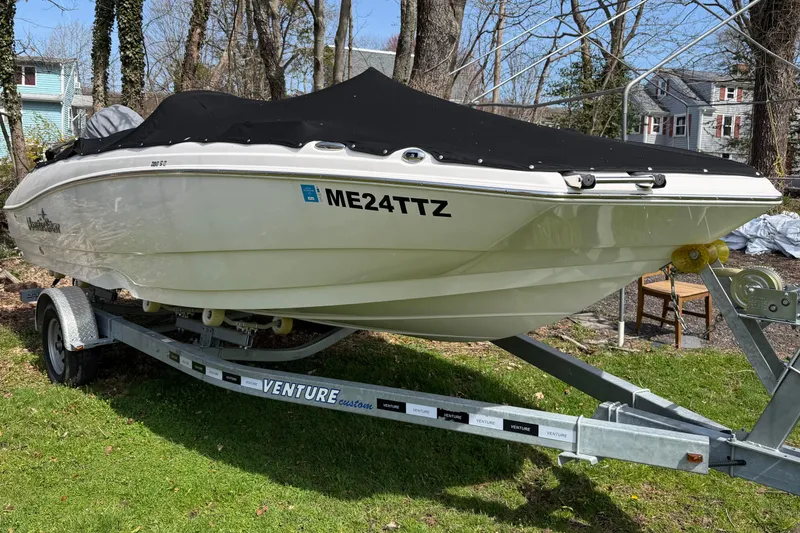 Slide: The Image of 2022 NauticStar 203 DC boat on trailer, covered, parked outdoors. - 3