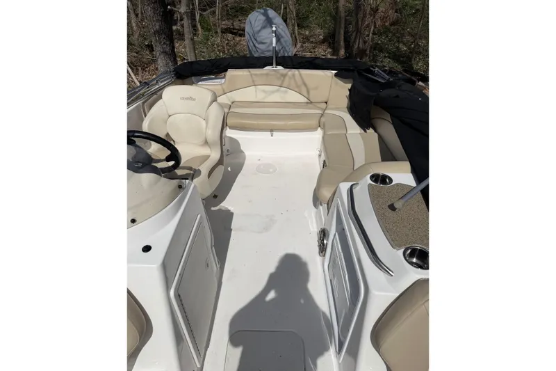 Slide: The Image of 2022 NauticStar 203 DC boat interior with beige seating and steering wheel. - 7