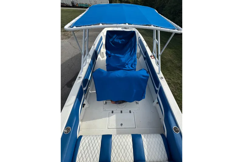 Slide: The Image of 2001 Fountain 31 Tournament Edition boat with blue and white seating and canopy. - 10