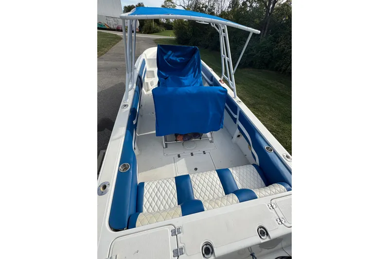 Slide: The Image of 2001 Fountain 31 Tournament Edition boat with blue and white seating, canopy, and spacious deck. - 15