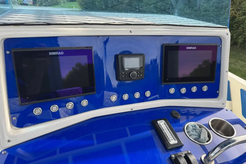 Slide: The Image of Control panel of a 2001 Fountain 31 Tournament Edition boat with Simrad displays. - 18
