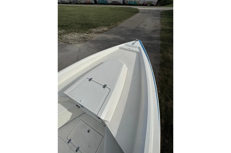 Slide: The Image of Bow view of 2001 Fountain 31 Tournament Edition boat on a paved path. - 22