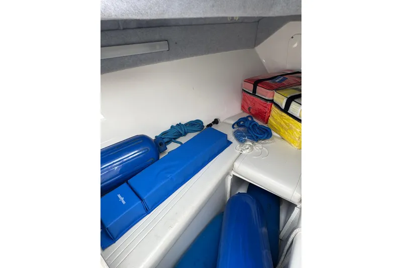 Slide: The Image of Storage area in a 2001 Fountain 31 Tournament Edition boat with ropes and cushions. - 30